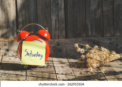 Saturday Note On Old Red Vintage Clock With Still Light, Natural Light.