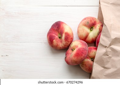 Saturn Peaches, Donut, Fig, UFO Or Flat Peaches With Leaves On White Wood Boards In Pack