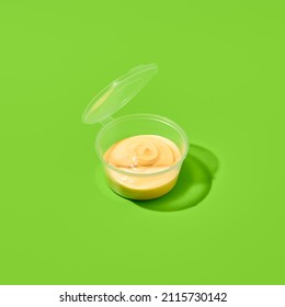 Sauce in plastic container on green background. Sauce package in minimal style. Takeaway food. Fast food menu. Portion of sauce for delivery. Takeout dip - Shutterstock ID 2115730142