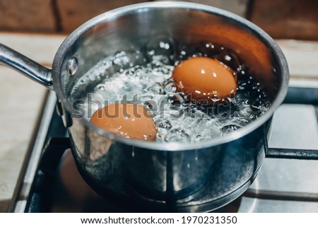 Saucepan with boiling eggs on a gas stove