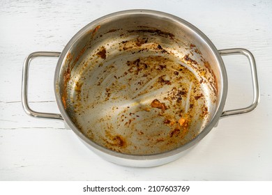 Saucepan, Dirty Saucepan With Burnt Food Leftovers In It. Cook Or Messy Kitchen Concept Photo