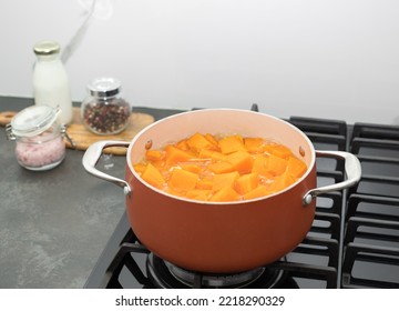 Saucepan with pumpkin soup on gas stove top in kitchen. Clean healthy food. top view - Shutterstock ID 2218290329