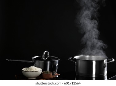 Saucepan With Steam On Black Background