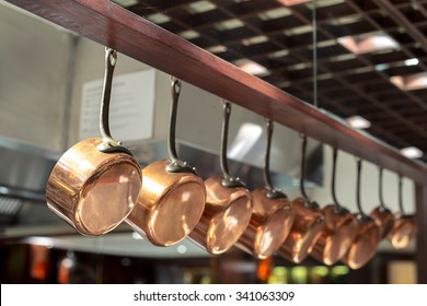 saucepans hanging from a rack in the  kitchen