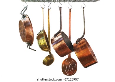 saucepans hanging from a rack in a traditional style kitchen