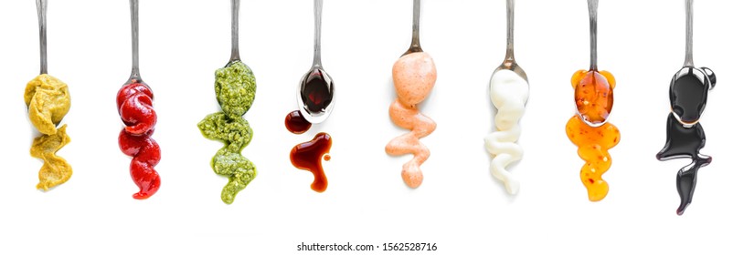 Sauces Assortment. Set of various sauces on spoons isolated on white, top view, copy space. 