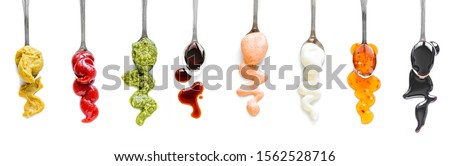 Sauces Assortment. Set of various sauces on spoons isolated on white, top view, copy space.  Stockfoto © 