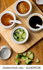 Sauces. Thai, Vietnamese, Chinese Or Japanese Restaurant Classic Condiment On A Lazy Susan. Peanut, Sweet Sauce, Soy And Pickled Cucumbers.