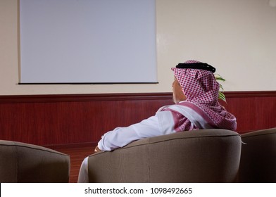 Saudi Arab Businessman Watching Large Projection Screen