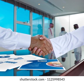 Saudi Arab Businessmen Shaking Hands, And Making Agreement Or A Deal In A Meeting Room