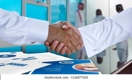 Saudi Arab Businessmen Shaking Hands, And Making Agreement Or A Deal In A Meeting Room