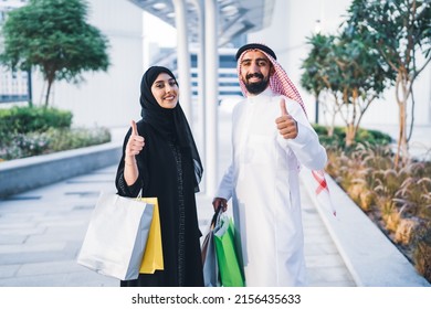 Saudi Arab Family Shopping Happy Carrying Sale Bags . Muslim Arabian Couple Shopper Enjoying Season Thumbs Up