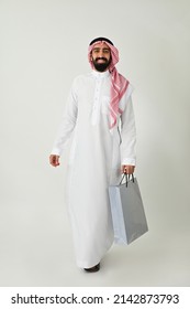 Saudi Arab Man Carrying Shopping Bags Walking Happy Isolated On Solid White Background