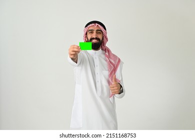 Saudi Arab Man Happy Paying With Credit Card Excited Isolated On Solid White Background. Debit Card Buying Offer Concept