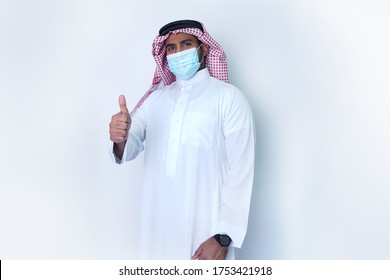 Saudi Arab Man Standing Confidentaly In Office Wearing Face Mask Post Resuming Work After COVID 19