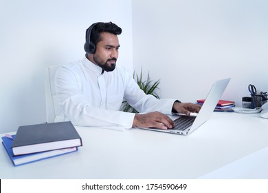 Saudi Arab Man Using Laptop And Wearing Headphone