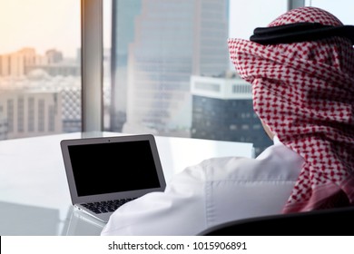 Saudi Arab Man Watching Laptop At Work And Contemplating