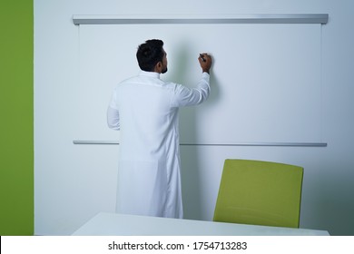 Saudi Arab Man Writing On White Board In Conference Room