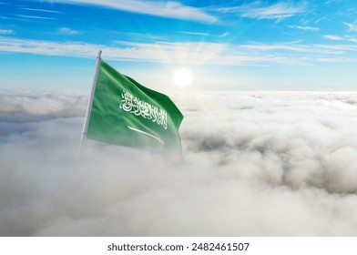 Saudi Arabia flag aerial view in beautiful sky with clouds. Top-down drone shot at sunrise or sunset. Aerial bird's eye view of the flag with cloudscape. - Powered by Shutterstock