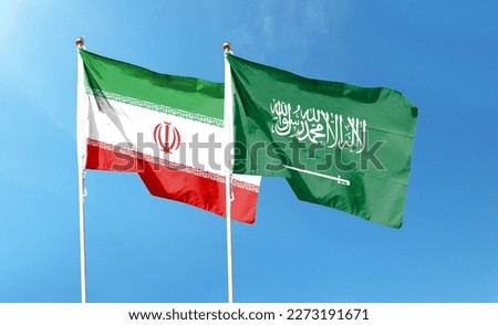 Saudi Arabia flag and Iran flag on cloudy sky. waving in the sky