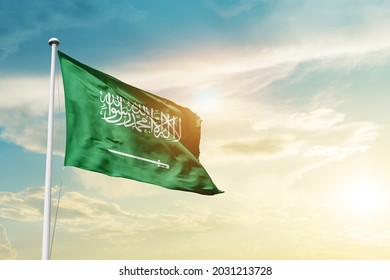 Saudi Arabia national flag waving in beautiful clouds. - Shutterstock ID 2031213728