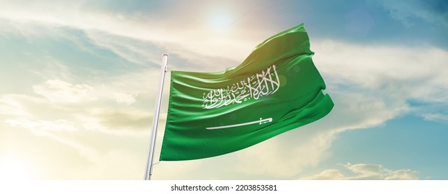 Saudi Arabia national flag waving in beautiful sky.