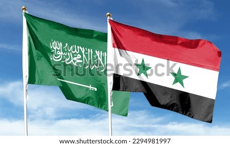 Saudi Arabian flag and Syria flag on cloudy sky. waving in the sky