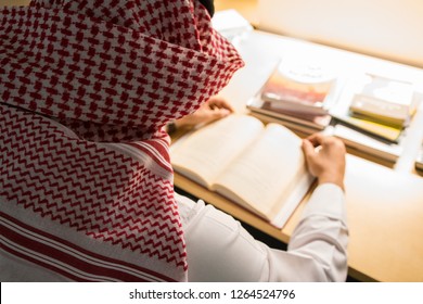 Saudi Arabian Man Reading A Book In The Library