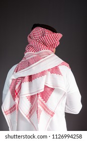 Saudi Arabian Man Wears Traditional Saudi Clothes (Shmag). Photograph Portrait From Behind.