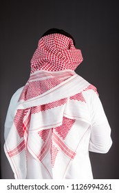 Saudi Arabian Man Wears Traditional Saudi Clothes (Shmag). Photograph Portrait From Behind.