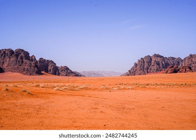 Saudi Arabia's Neom desert rock formations, shaped by nature's forces over time. From rugged cliffs to smooth surfaces, they stand against the vast desert backdrop, a testament to geological history. - Powered by Shutterstock