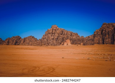 Saudi Arabia's Neom desert rock formations, shaped by nature's forces over time. From rugged cliffs to smooth surfaces, they stand against the vast desert backdrop, a testament to geological history. - Powered by Shutterstock