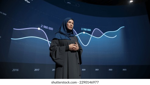 Saudi Businesswoman Making a Presentation on Stage During a Middle Eastern Business Conference. Entrepreneur in Hijab Talking About Financial Growth, New Market Development, Marketing Strategy - Powered by Shutterstock