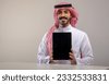 saudi man holding tablet