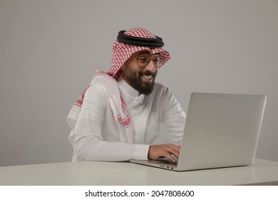 A saudi character using laptop so happy on withe background
 - Shutterstock ID 2047808600