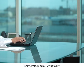 Saudi Man Hands Typing On Laptop At His Desk. Headless