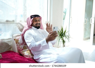 Saudi Man Video Calling At Home Sitting At Sofa In Living Room