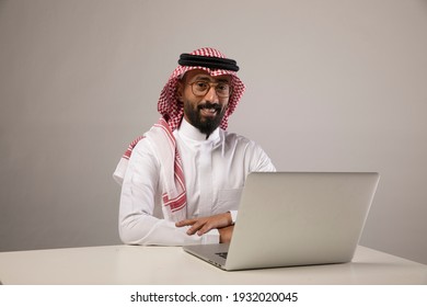A saudi person sits at his desk - Shutterstock ID 1932020045