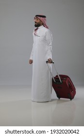 A Saudi Person Traveling And Pull Out A Travel Bag On White Background  