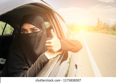 Saudi Woman Driving A Car On The Road. Muslim Woman Driver Concept