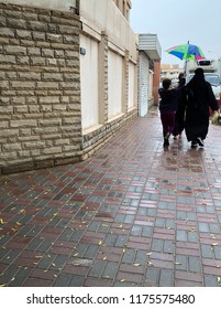 Saudi Woman And Her Daughters Walk Under An Umbrella In Riyadh, Saudi Arabia