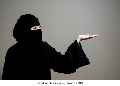 Saudi Woman Portrait Wearing Niqab And Holding An Object