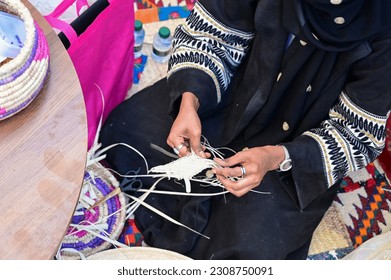Saudi woman wearing traditional cloth and doing hand made craft products. Riyadh Saudi Arabia.