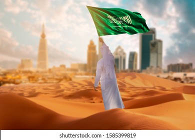 Saudi Young Arab Man Holding Saudi Arabia  Flag, Celebrating The National Day