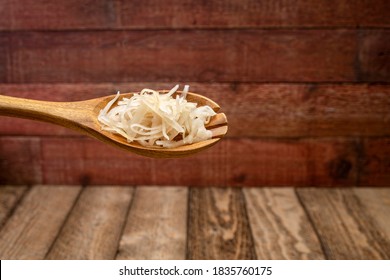 Sauerkraut (fermented Cabbage) On A Wooden Spoon Against Rustic Barnwood Background, Probiotics Concept - Fermented Food Good For Gut Health