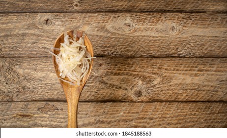 Sauerkraut (fermented Cabbage) On A Wooden Spoon Against Rustic Barnwood Background, Probiotics Concept - Fermented Food Good For Gut Health