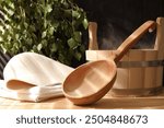 Sauna equipment. Bucket, ladle, felt wool hat and towel on bamboo bench