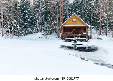 Sauna House In Winter Forest Nearby The Lake With Ice-hole