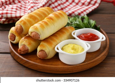 Sausage Baked In Dough With Ketchup And Mustard