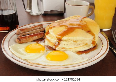 A Sausage And Egg Breakfast With Pancakes